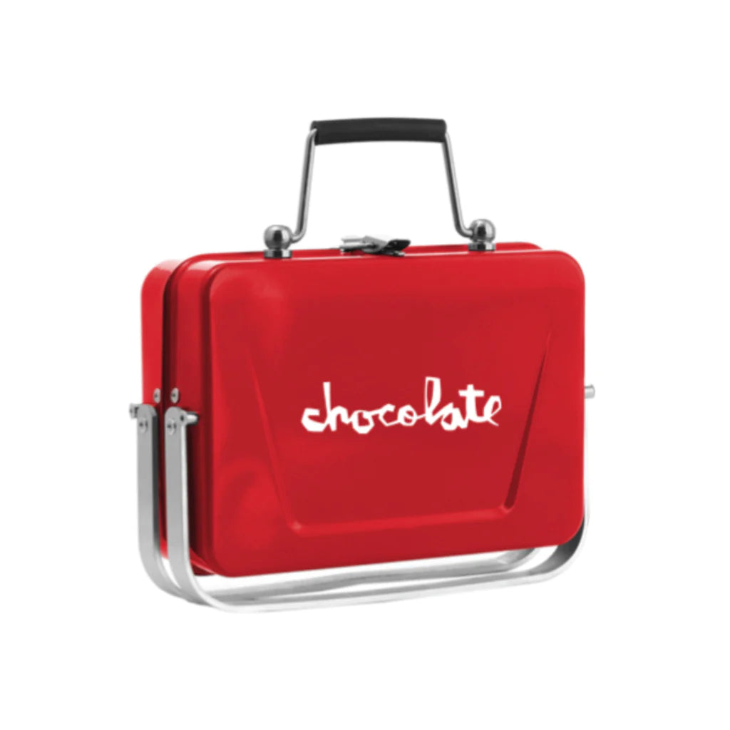 A red lunch box with the word CHOCOLATE SPOT GRILL on it.