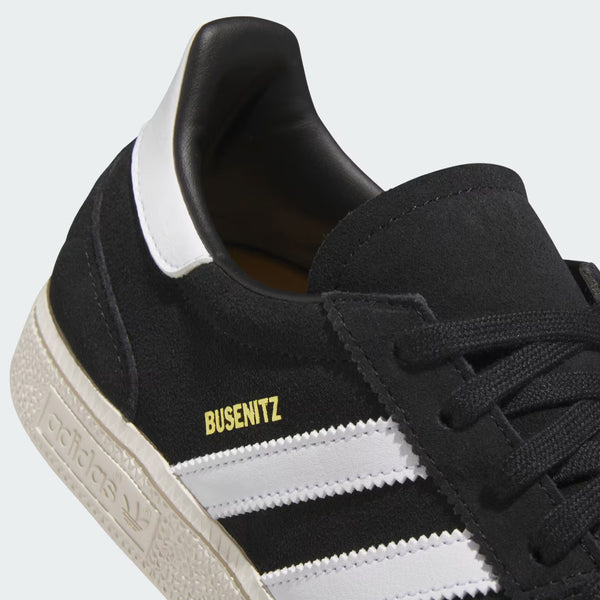 Close-up of a Core black and white ADIDAS BUSENITZ VINTAGE BLACK / WHITE sneaker made from durable textile, showing the brand logo and name on the side.