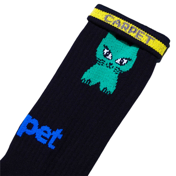 The STANCE CARPET CO. CAT SOCK BLACK features a bold yellow and blue "CARPET" logo by the cuff and a playful green cartoon cat below it—ideal for fans of unique cat socks.