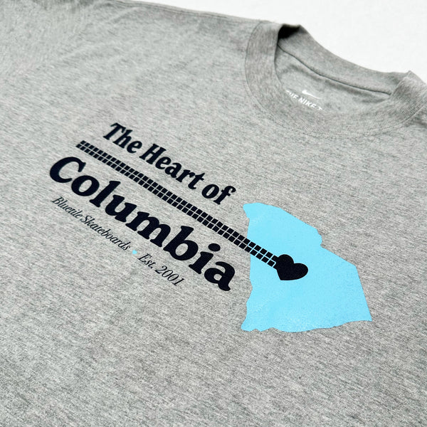 Bluetile Skateboards BLUETILE HEART OF COLUMBIA TEE ASH featuring a blue silhouette of the state of South Carolina, a guitar neck, and the text "Heart of Columbia. Famously hot. Est. 2002.