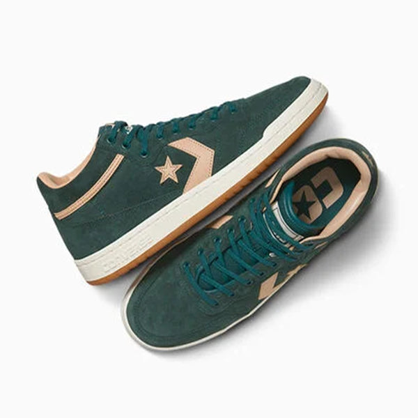 A pair of green CONVERSE CONS FASTBREAK PRO MID sneakers with white soles and tan star logos, made from durable Cordura canvas, is displayed on a plain white background from side and top views.