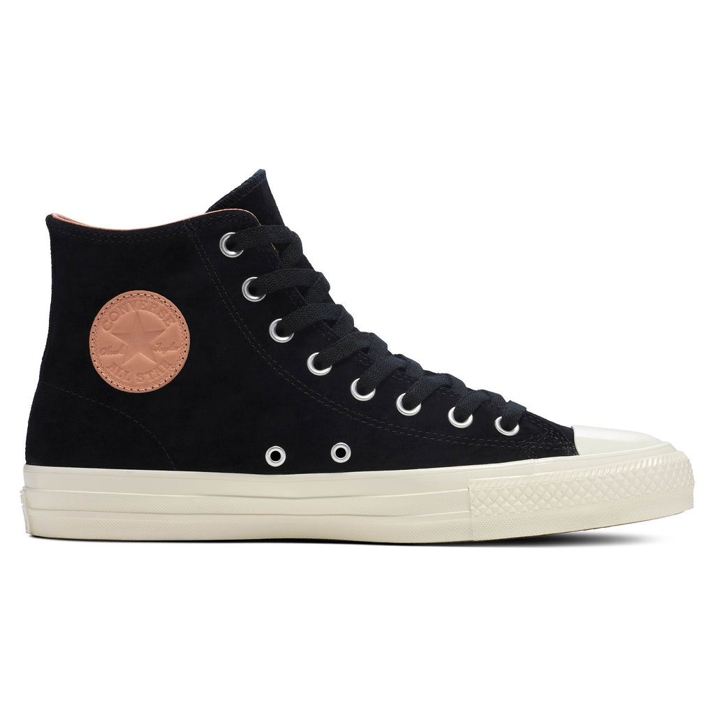 The CONVERSE CONS Chuck Taylor All Star Pro Nubuck in black/vachetta beige, featuring a white sole and tan circular patch, draws inspiration from the iconic design and is ideal for skateboarding enthusiasts.