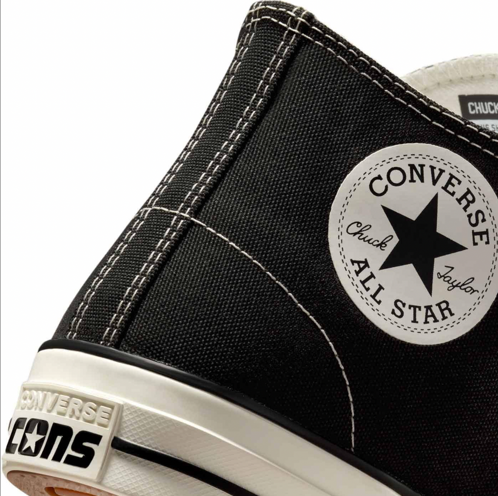 A close up of a black Converse Cons Chuck Taylor All Star Pro Mid Black/Black/Egret shoe.