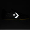 The CONVERSE CONS LOUIE LOPEZ PRO 2 TOTAL ECLIPSE / SWAMP CORE is a black skate shoe with a reflective white star and chevron logo on the side, crafted from full-grain leather to stand out against dark backgrounds.