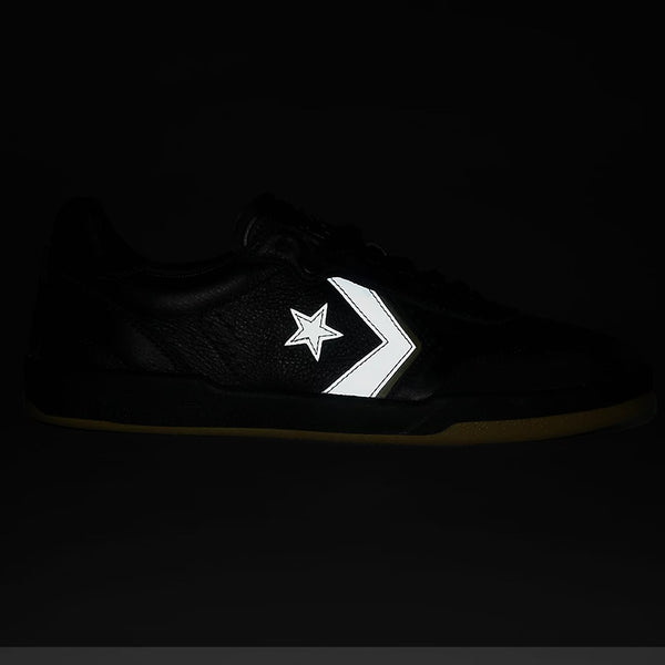 The CONVERSE CONS LOUIE LOPEZ PRO 2 TOTAL ECLIPSE / SWAMP CORE is a black skate shoe with a reflective white star and chevron logo on the side, crafted from full-grain leather to stand out against dark backgrounds.