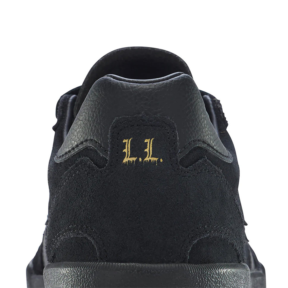 Close-up rear view of the CONVERSE CONS LOUIE LOPEZ PRO 2 SUEDE BLACK / GUM skate shoe, featuring "L.L." in gold on the heel.