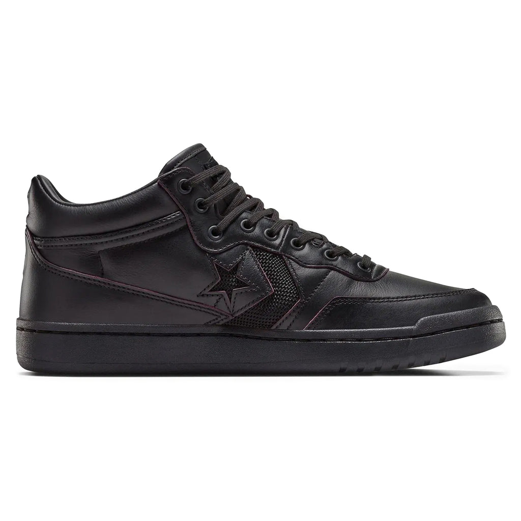 The CONVERSE CONS Remy Taveira Fastbreak Pro Mid in black by CONVERSE features a star logo, high-top design, and flat rubber sole. It includes CX cushioning for added comfort and a durable nubuck upper for style.