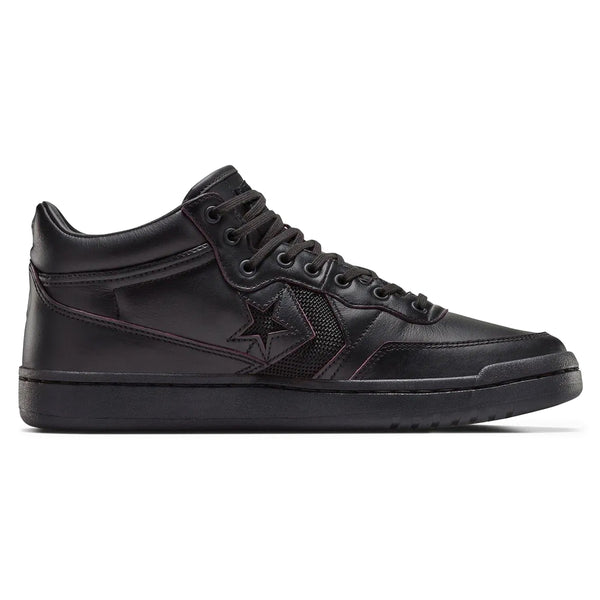 The CONVERSE CONS Remy Taveira Fastbreak Pro Mid in black by CONVERSE features a star logo, high-top design, and flat rubber sole. It includes CX cushioning for added comfort and a durable nubuck upper for style.