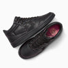 The CONVERSE CONS Remy Taveira Fastbreak Pro Mid features a nubuck upper with a star logo. It comes in all black with floral-patterned insoles, black laces, and one shoe displayed sideways while the other highlights its sole.