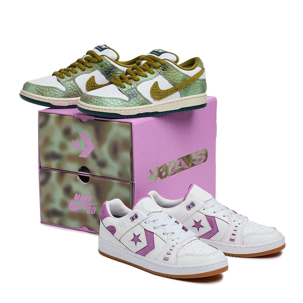 Two pairs of sneakers are displayed, one with a green and brown camouflage pattern, the other white with purple accents. Both are placed on a *Raffle Winner* NIKE SB X CONVERSE CONS "CHAMELEON" DOUBLE BOX featuring green camouflage and "Nike SB" branding.