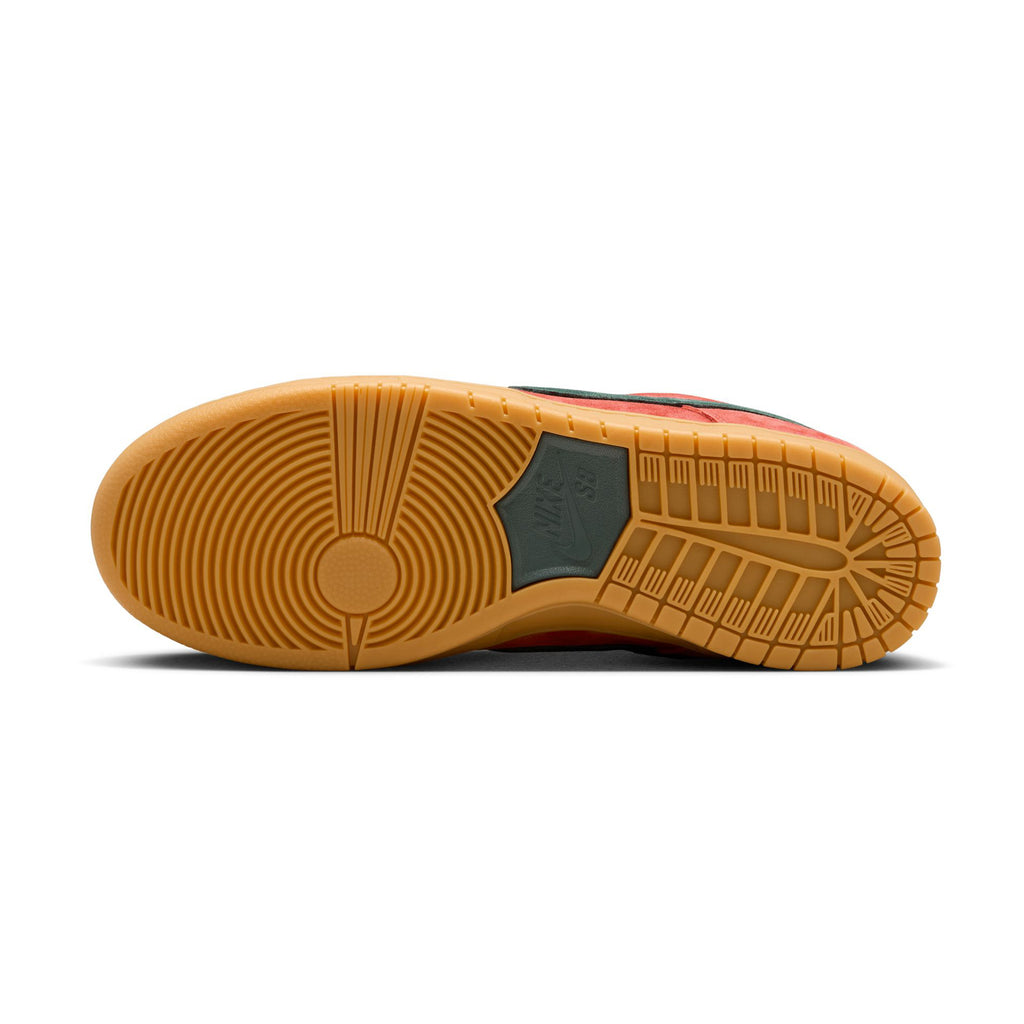 Bottom view of a nike NIKE SB DUNK LOW PRO BURNT SUNRISE / VINTAGE GREEN sneaker with a light brown rubber sole, featuring a combination of circular and linear tread patterns. The foam midsole area has a darker inset.