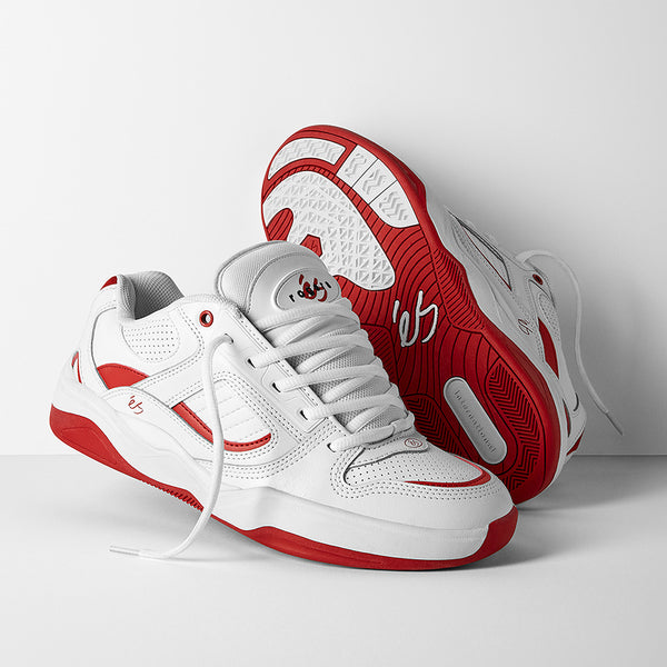 The ES éS TJ ROGERS WHITE / RED sneakers feature white uppers with red accents; one shoe stands upright while the other lies on its side, displaying the sole’s tread and an E-Bound midsole for enhanced impact resistance.