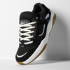 The ES éS TJ ROGERS BLACK / BLUE / WHITE skate shoe features a black and white upper with blue accents, a tan cupsole, white laces, and tongue branding, showcased against a simple background.