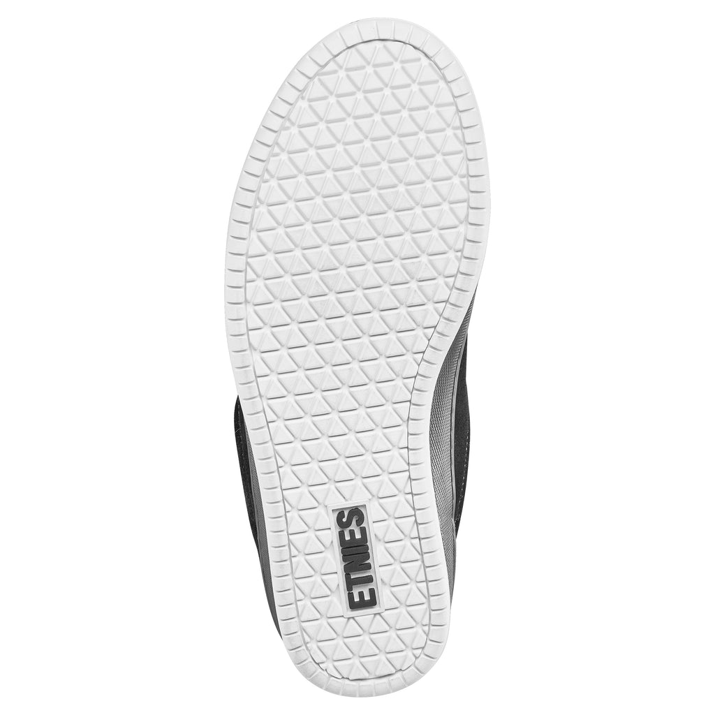 The underside of the ETNIES SAL 23 BLACK / WHITE skate shoe features a geometric white sole pattern and the iconic "Etnies" branding, reflecting the innovative spirit inspired by Salvador "Sal" Barbier.