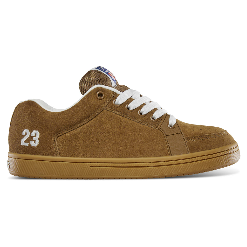 The ETNIES SAL 23 BROWN / GUM sneaker showcases a design inspired by Salvador Barbier, featuring brown suede material, white laces, and a gum sole, with "23" embroidered on the side reminiscent of Etnies' iconic skate shoe style.