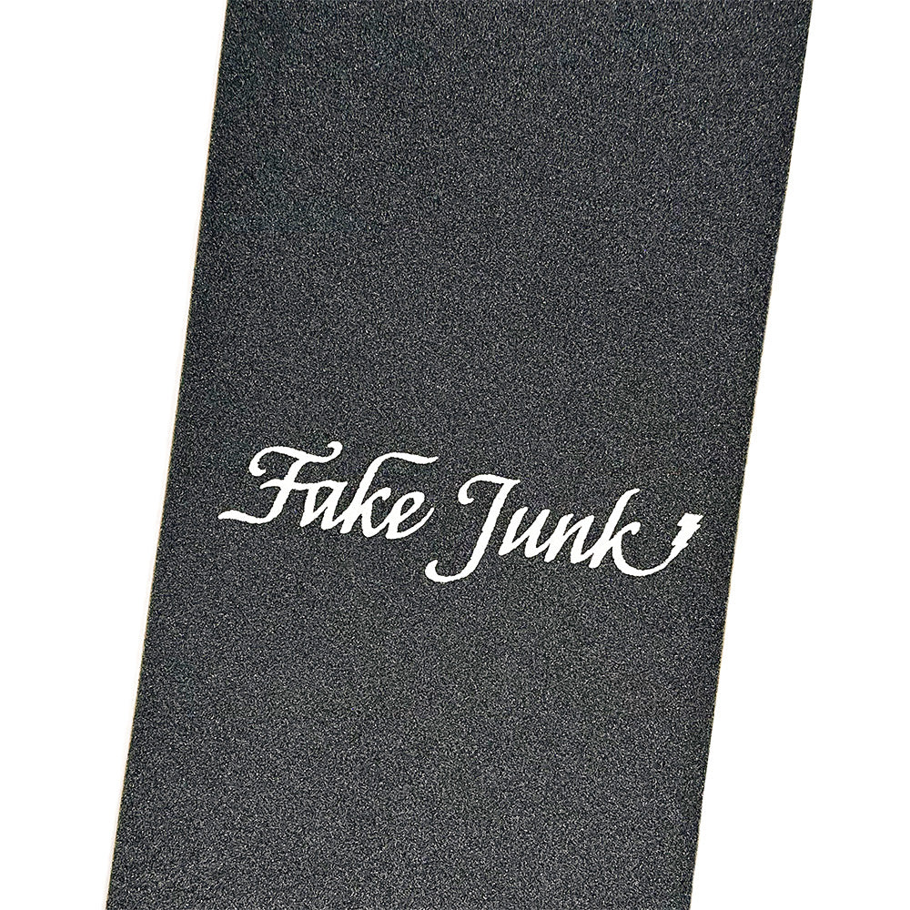 A black FAKE JUNK GRIPTAPE TRAMP STAMP MOREGRIP FORMULA sheet with "Fuke Junk" in white script at the center, made by FAKE JUNK for enhanced traction.