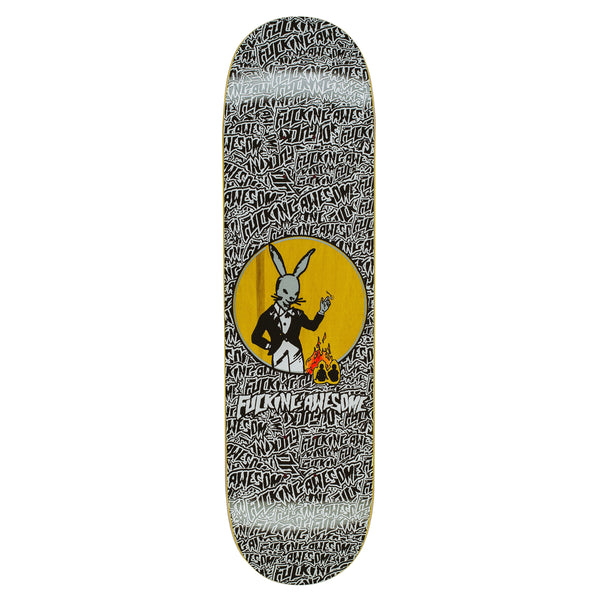 A FUCKING AWESOME THE COMEDIAN skateboard deck featuring a pattern of "FUCKING AWESOME" text, with an illustration of a tuxedo-wearing rabbit holding a flaming card in a central yellow circle. This design embodies the bold and edgy style that CHLOË SEVIGNY is known for.