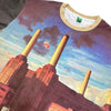 A HABITAT X PINK FLOYD ANIMALS TEE featuring an image of chimneys with a flying pig among clouds in the background, reminiscent of Pink Floyd's iconic "Wish You Were Here" vibe.