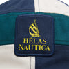 Close-up of the HELAS X NAUTICA AUBERT STRAPBACK CAP in dark navy, featuring a patterned fabric and a patch with a sailboat and the text "HÉLAS NAUTICA" in yellow.