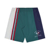 These HELAS X NAUTICA YANNICK 8.5" Swim Shorts in moss green feature a combination of light blue, navy blue, and white panels, accented with red and white stripes on one side. They also include an embroidered "HÉLAS NAUTICA" logo and a small graphic for added style.