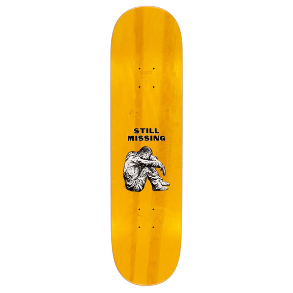 HOCKEY STILL MISSING skateboard deck by HOCKEY with a yellow background featuring an illustration of a seated figure and the text "STILL MISSING," boasting a slick bottom for smooth rides.