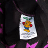 A close up of a label with a cartoon character wearing the Carpet Co. C-STAR BEANIE BLACK on a Carpet.
