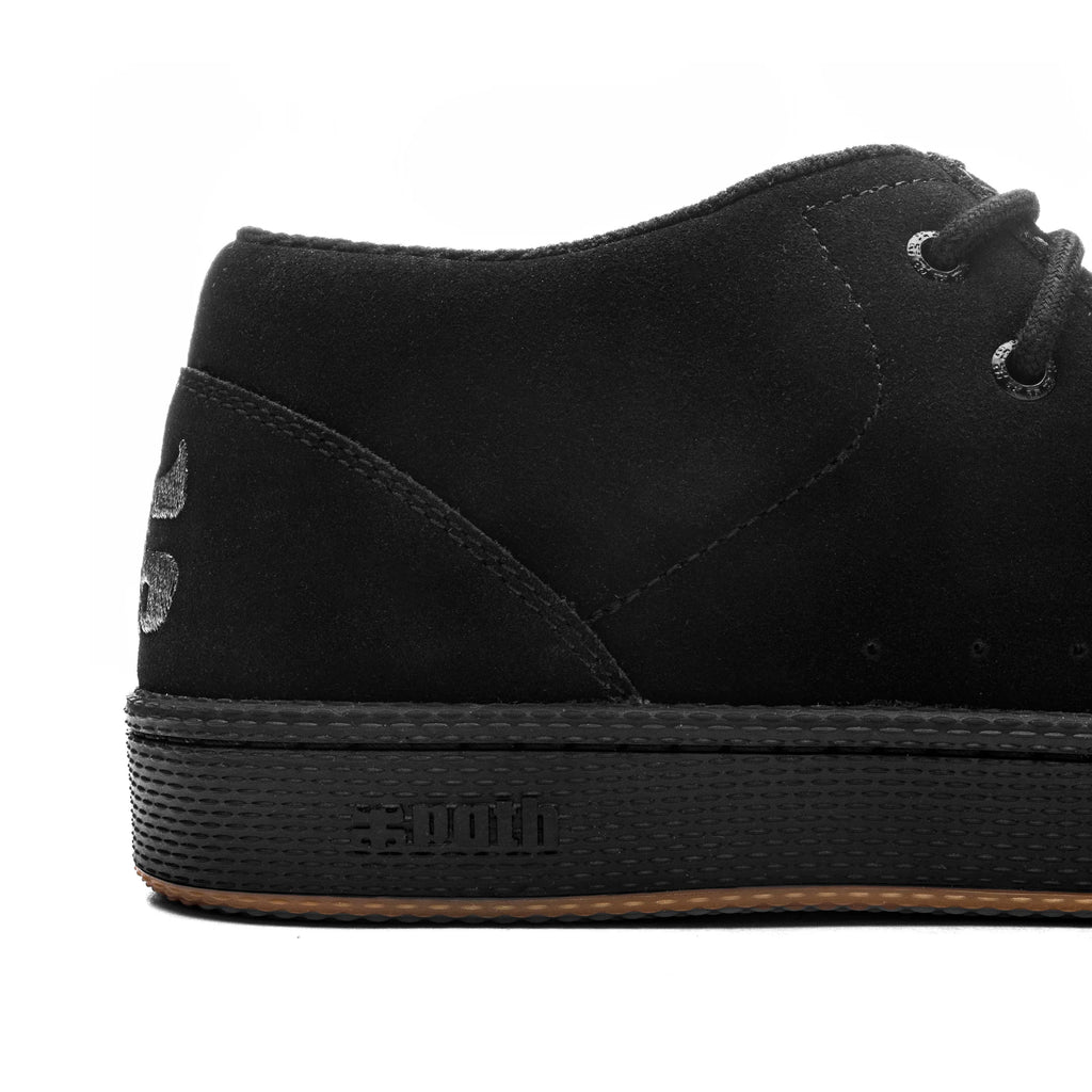 Close-up of the heel of the IPATH CATS BLACK SUEDE high-top sneaker with stitched detailing and visible laces. The shoe, made from sleek black suede, features a rubber sole with a textured pattern and the IPATH logo on the side.