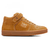 Side view of the IPATH GRASSHOPPER COGNAC SUEDE high-top sneaker from IPATH, showcasing a tan suede finish with a lace-up design, a Velcro strap near the ankle for added support, and a textured rubber sole. An embossed logo is visible on the shoe's side.