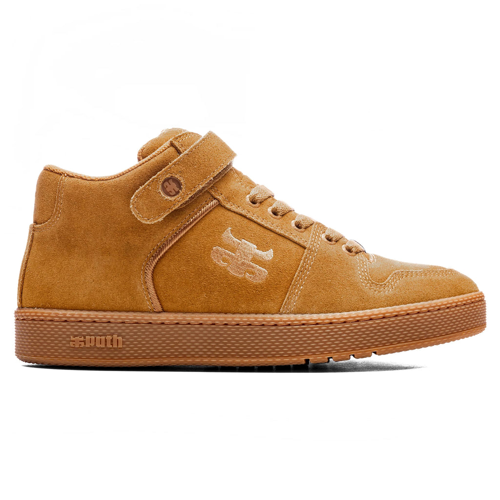 Side view of the IPATH GRASSHOPPER COGNAC SUEDE high-top sneaker from IPATH, showcasing a tan suede finish with a lace-up design, a Velcro strap near the ankle for added support, and a textured rubber sole. An embossed logo is visible on the shoe's side.