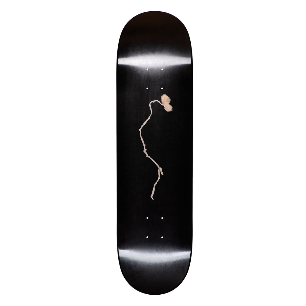 A black LIMOSINE YUZI STRING skateboard with a drawing of a woman on it.