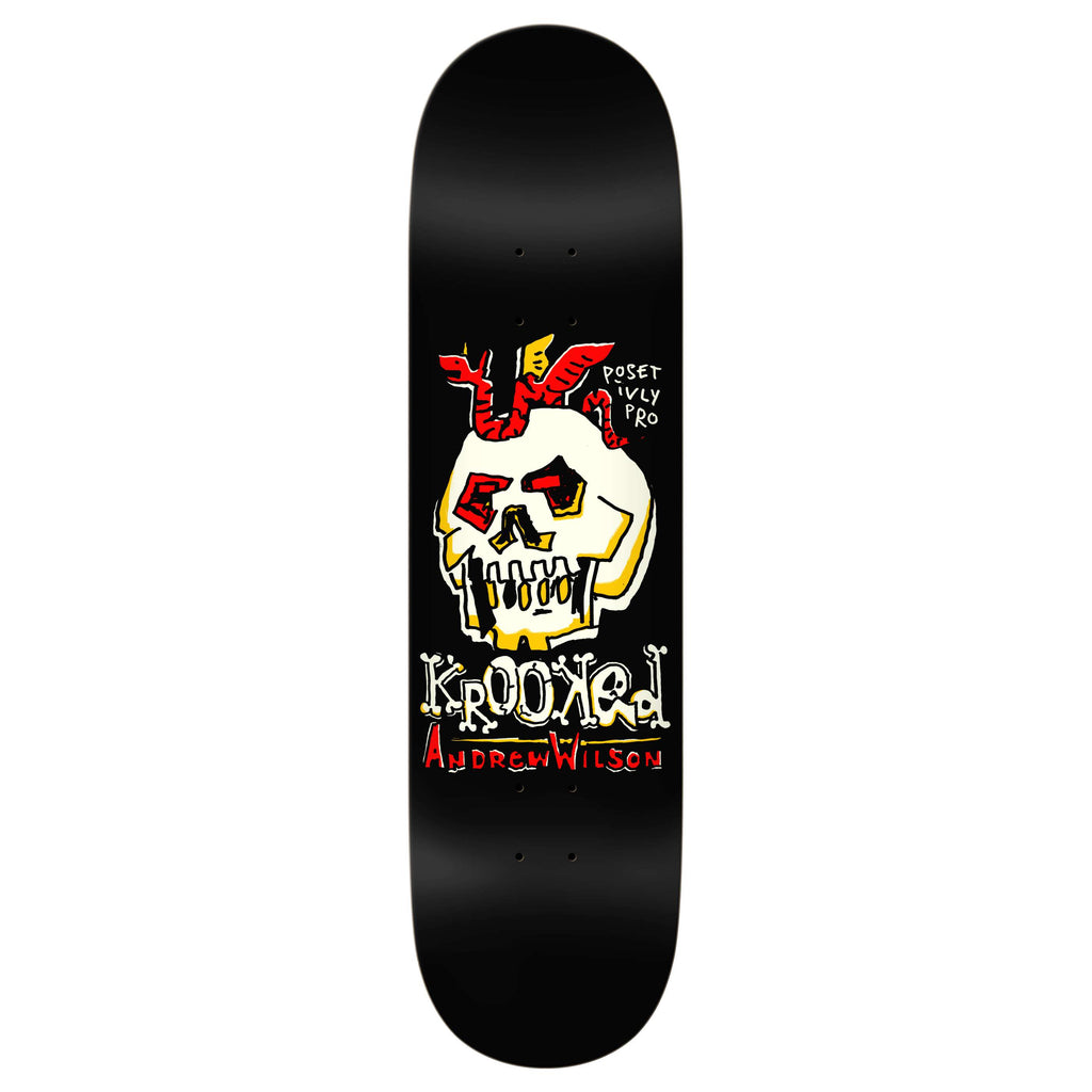 Introducing the KROOKED WILSON POSITIVELY PRO, a sleek black skateboard deck adorned with a skull graphic featuring red horns, prominently showcasing the text "Krooked" and "Andrew Wilson." Ideal for adrenaline enthusiasts, this deck embodies an edgy style that echoes the thrilling speed of a racecar on pavement.