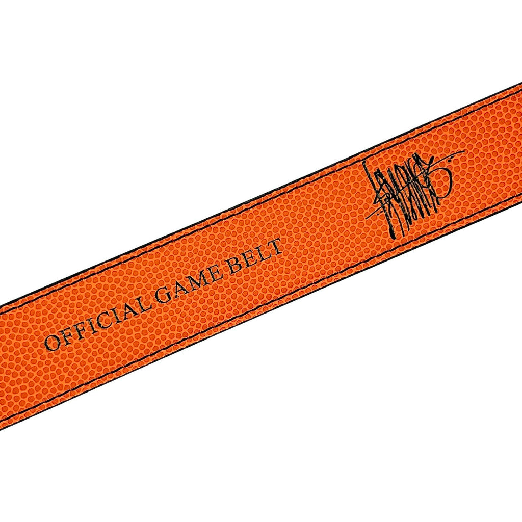 A close-up of the LOOSEY ISHOD WAIR PRO (OFFICIAL GAME BELT) by Loosey, showcases an orange textured belt with rivets and a strong buckle. It features an illegible signature, adding rugged charm—ideal for pairing with denim.