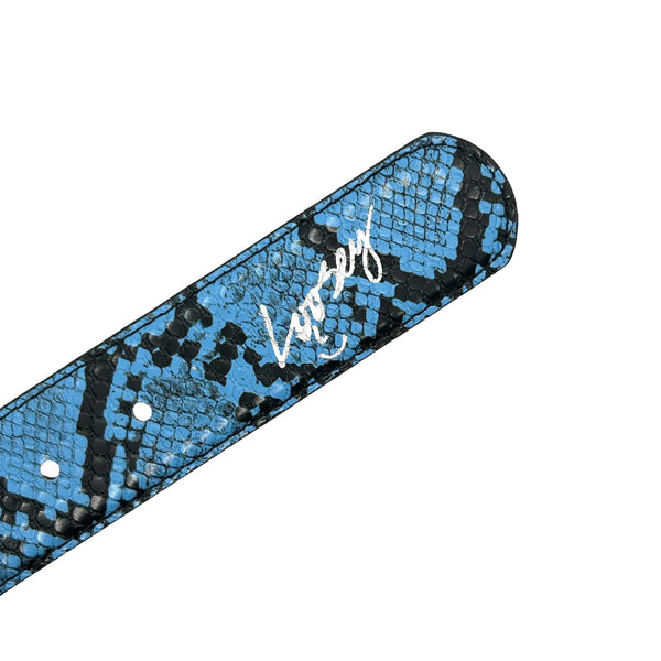 Close-up of a blue and black snakeskin textured strap with a charcoal buckle, adorned with the word "Loosey" written in white script on it.