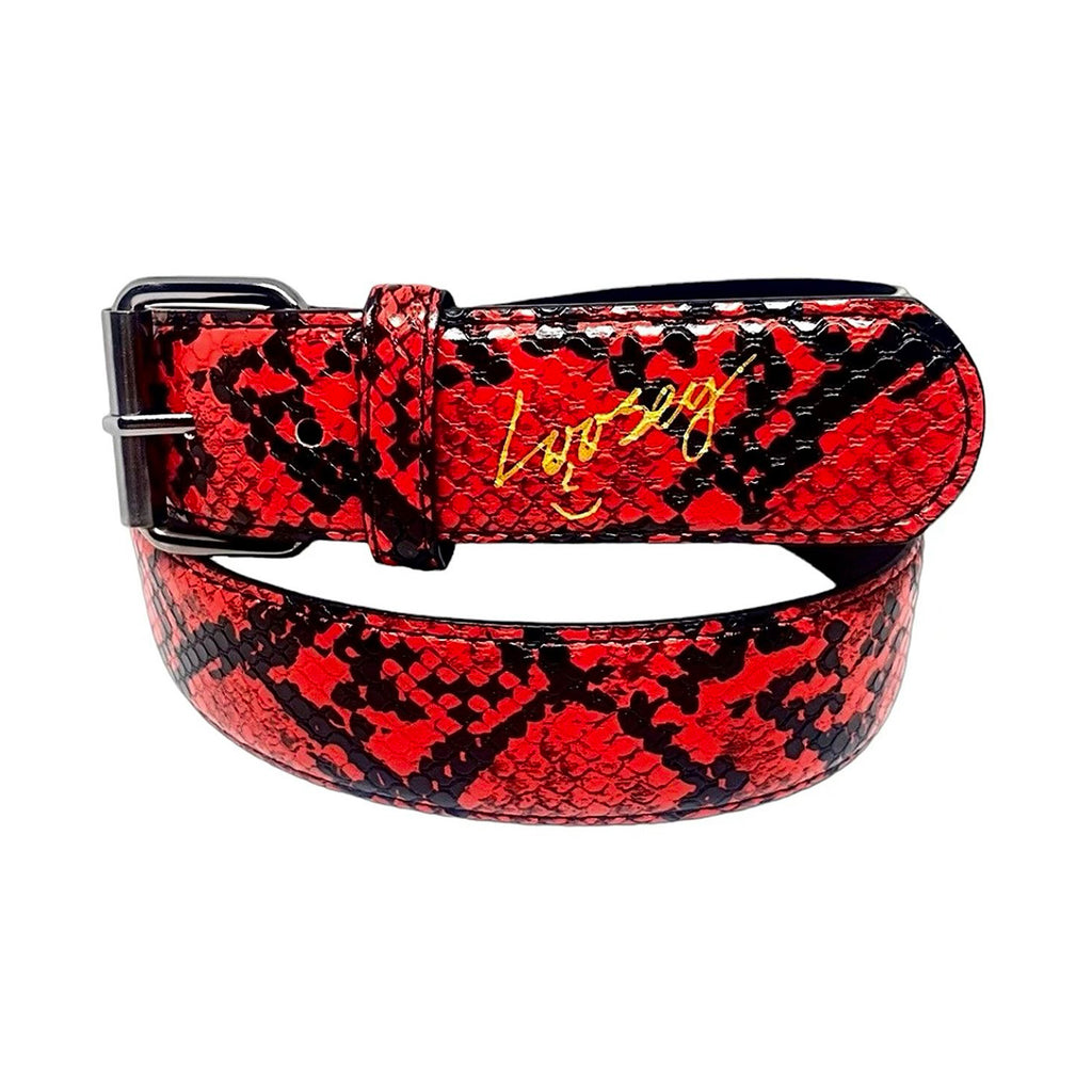 Close-up of the Loosey LOOSEY SLITHER BELT RED, highlighting its faux leather snakeskin pattern in striking red with a sleek charcoal buckle and the word "love" elegantly written in gold on the strap.