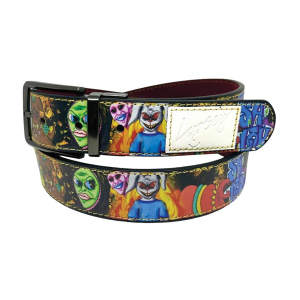 A colorful belt featuring a mix of various character and face designs, with a gold buckle and a white faux leather croc skin patch with an inscription is the LOOSEY "TAN MAN" REVERSIBLE BELT by Loosey.