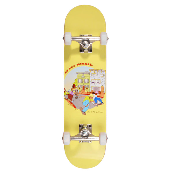 A vibrant yellow mini skateboard for kids, featuring white wheels and a playful cartoon illustration. Designed by Karl Watson, it's titled "MY FIRST SKATEBOARD S.F. MINI COMPLETE" and is perfect for young skaters.