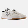NB NUMERIC 480 WHITE / BLACK / GUM by NB NUMERIC are white athletic shoes with black accents, featuring "N" logos on the sides, gum-colored outsoles, and an ABZORB in-sole for added comfort.