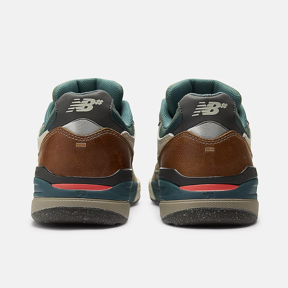 Rear view of NB NUMERIC REYNOLDS 933 skate shoes in Mushroom/New Spruce with brown leather, green accents, the NB logo on the heel, and ABZORB midsole, shown against a plain white background.