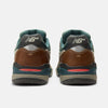 Rear view of NB NUMERIC REYNOLDS 933 skate shoes in Mushroom/New Spruce with brown leather, green accents, the NB logo on the heel, and ABZORB midsole, shown against a plain white background.