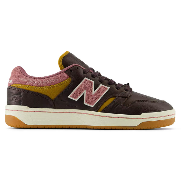 Side view of a NB Numeric 480 x 303 Boards X Jeremy Fish basketball shoe in burgundy with a yellow logo and pink textured accents on a white background.