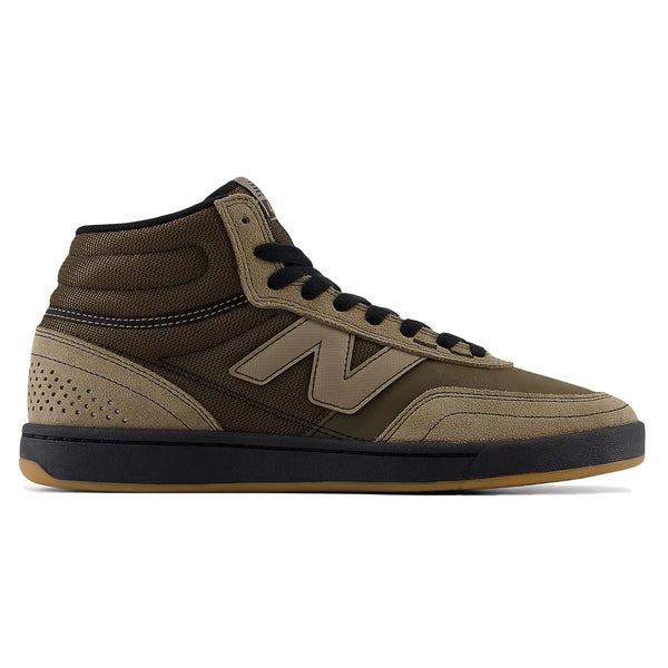 Side view of the NB NUMERIC 440 HIGH V2 MUSHROOM / BLACK, a brown high-top sneaker with black laces, a black midsole, and a gum outsole. Designed as an everyday skater's choice, this cupsole skate shoe features a mesh upper with suede accents and a distinctive "N" logo on the side.