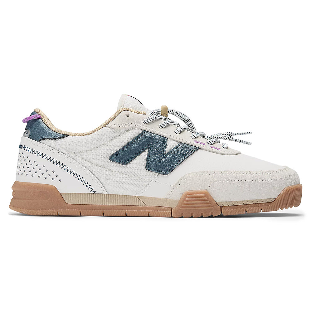 The NB NUMERIC 440 V2 TRAIL LOW SEA SALT / DEEP OCEAN blends white and beige uppers, a gum sole, teal “N” logo, teal and purple accents, patterned laces, and FuelCell cushioning for skate style with premium comfort.