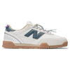 The NB NUMERIC 440 V2 TRAIL LOW SEA SALT / DEEP OCEAN blends white and beige uppers, a gum sole, teal “N” logo, teal and purple accents, patterned laces, and FuelCell cushioning for skate style with premium comfort.