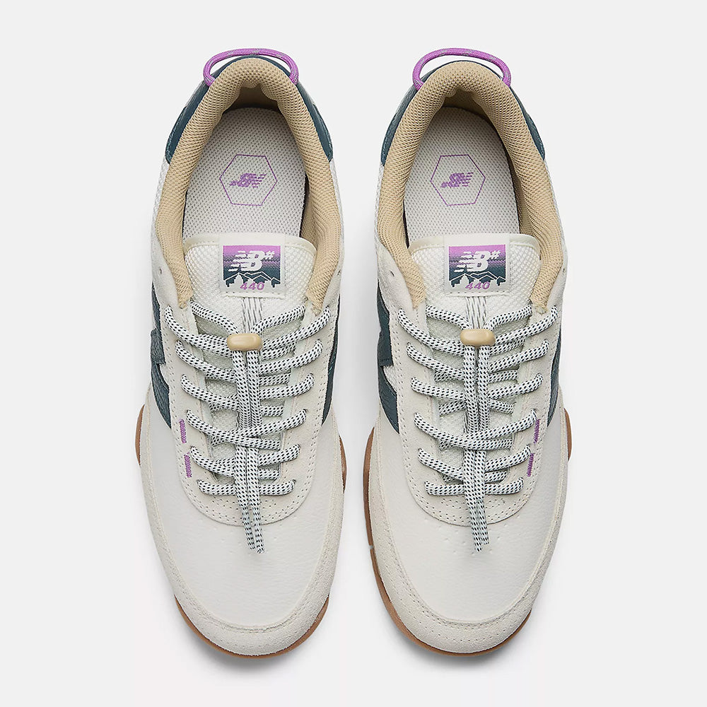 Top view of NB NUMERIC 440 V2 TRAIL LOW SEA SALT / DEEP OCEAN skate shoes in white and green with purple accents, patterned laces, tan lining, gum soles, and signature NB Numeric details on a white background.