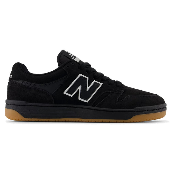 A black NB NUMERIC NB NUMERIC 480 BLACK / WHITE / GUM sneaker with a gum sole, white "N" logo on the side, and black laces, viewed from the side.