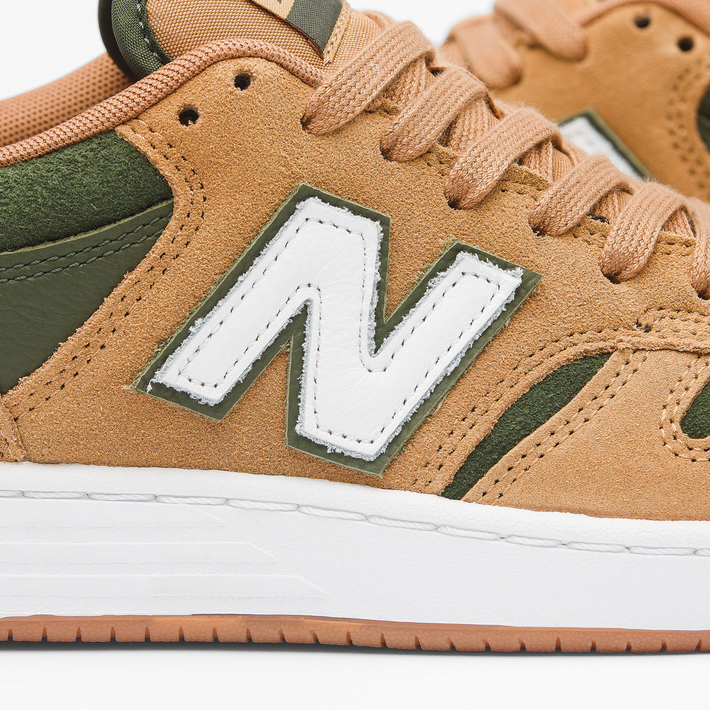 Replace the product in the sentence below with the given product name and brand name.
Sentence: New balance 480 SUEDE TAN, NB NUMERIC.

New balance NB NUMERIC 480 SUEDE TAN / GREEN, NB NUMERIC.