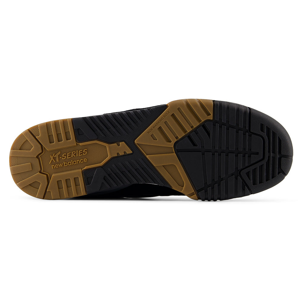 The image shows the outsole of the NB NUMERIC 770 BLACK / GREY skate shoe, featuring a black and brown rubber tread pattern with the NB NUMERIC brand name and model embossed.