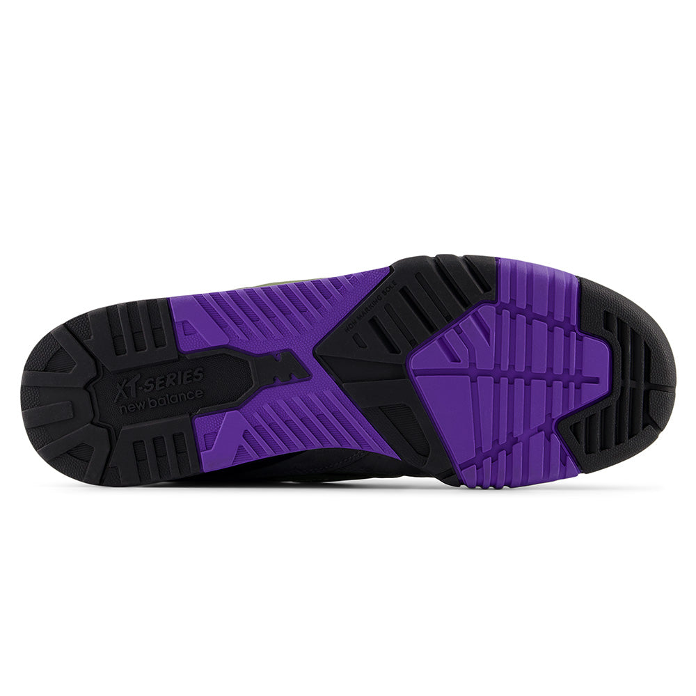 The image displays the grey, black, and purple rubber outsole of the NB NUMERIC 770 skate shoe by NB NUMERIC, featuring textured tread patterns, the brand logo, and FuelCell foam for added comfort.