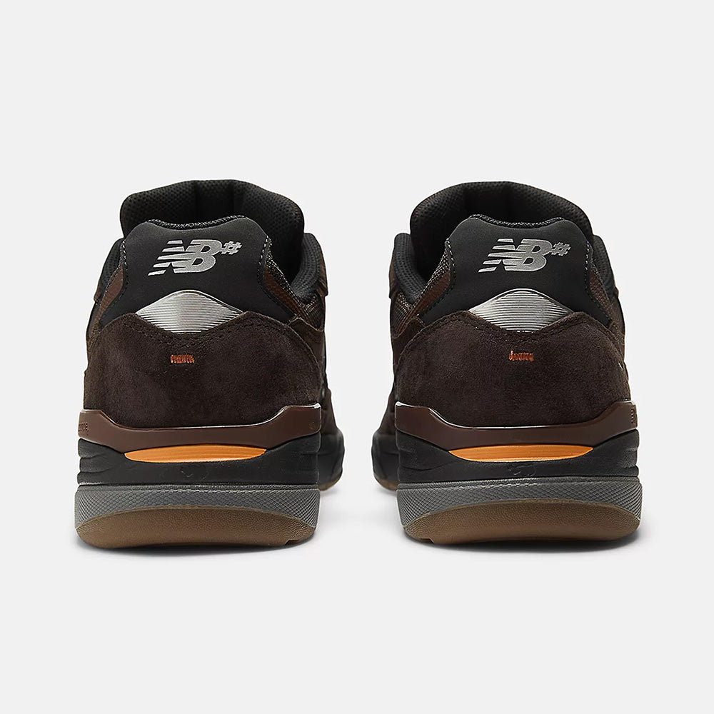 Rear view of NB NUMERIC REYNOLDS 933 sneakers in brown and black, showing the "NB" logo, reflective heel accents, and a comfy ABZORB midsole.