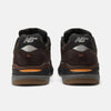 Rear view of NB NUMERIC REYNOLDS 933 sneakers in brown and black, showing the "NB" logo, reflective heel accents, and a comfy ABZORB midsole.